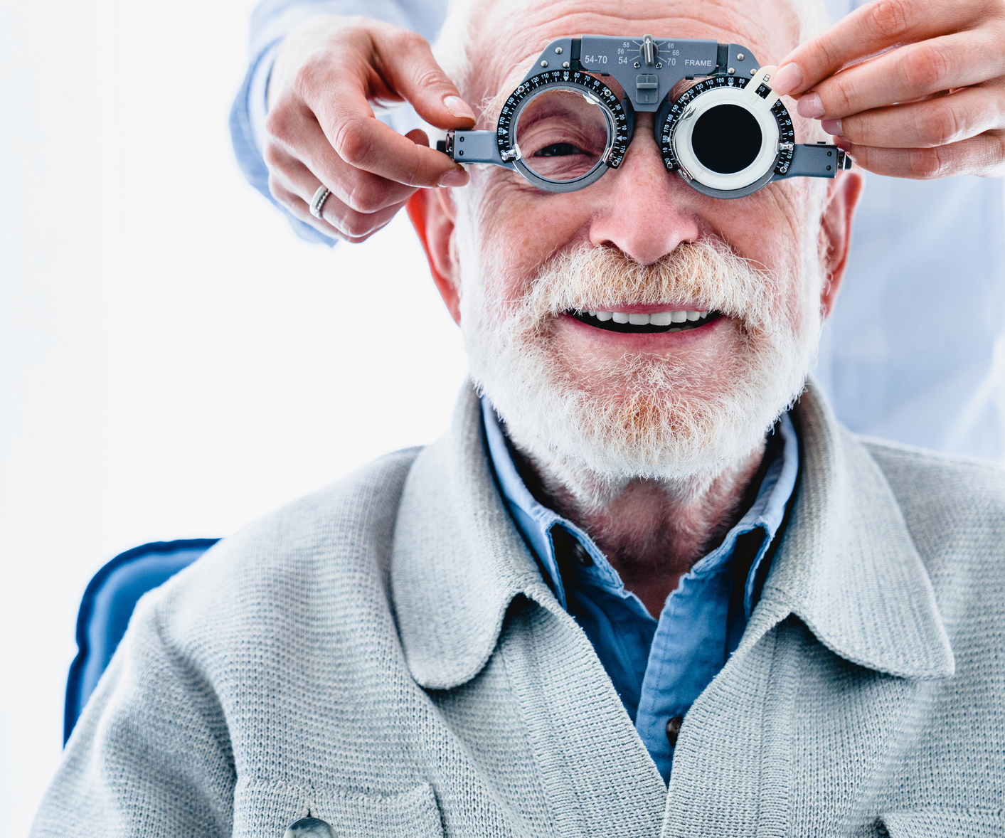 Portrait of a happy mature male patient undergoing vision check with special ophthalmic glasses