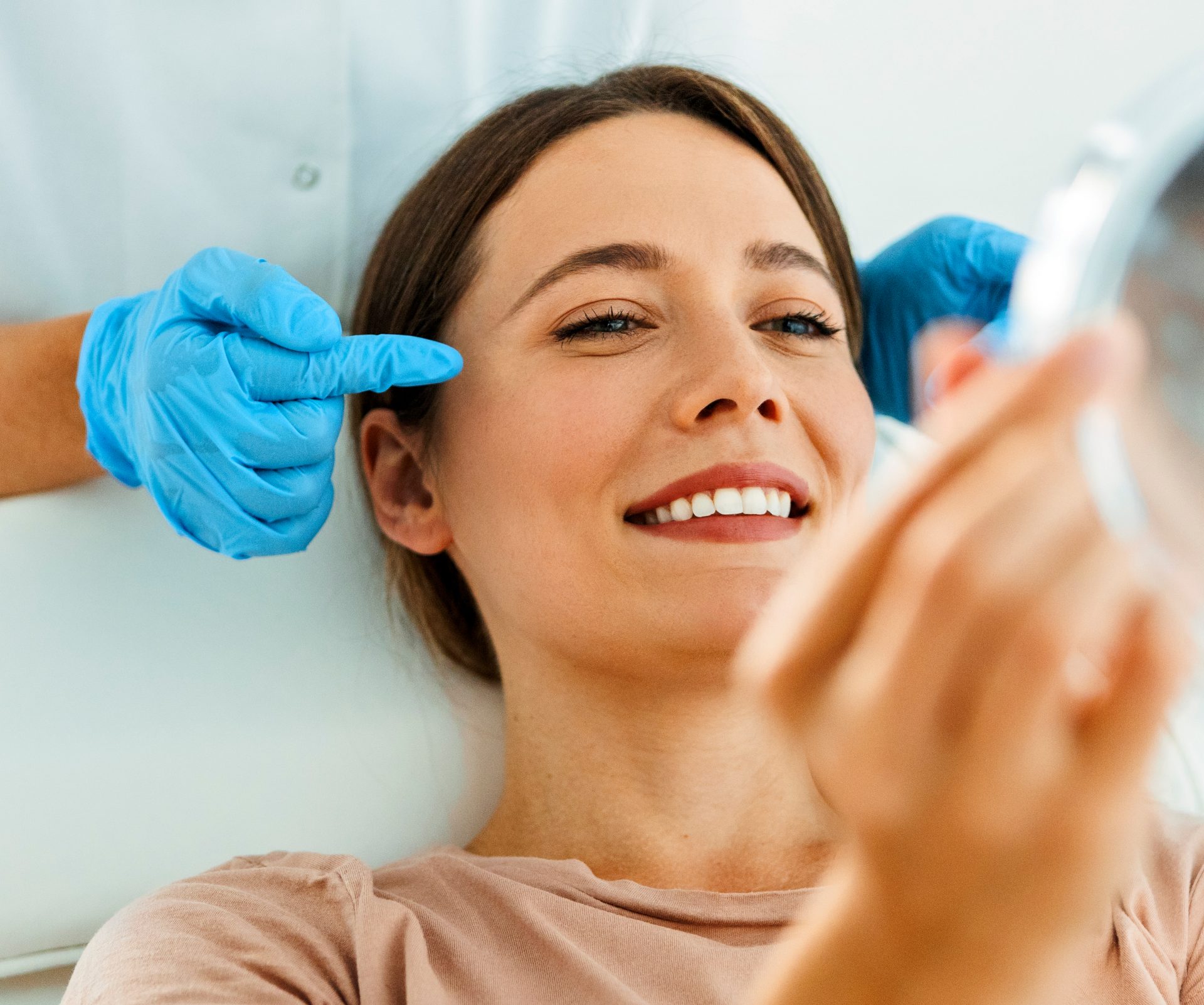 Beautiful Woman on Facial Treatment looking at mirror