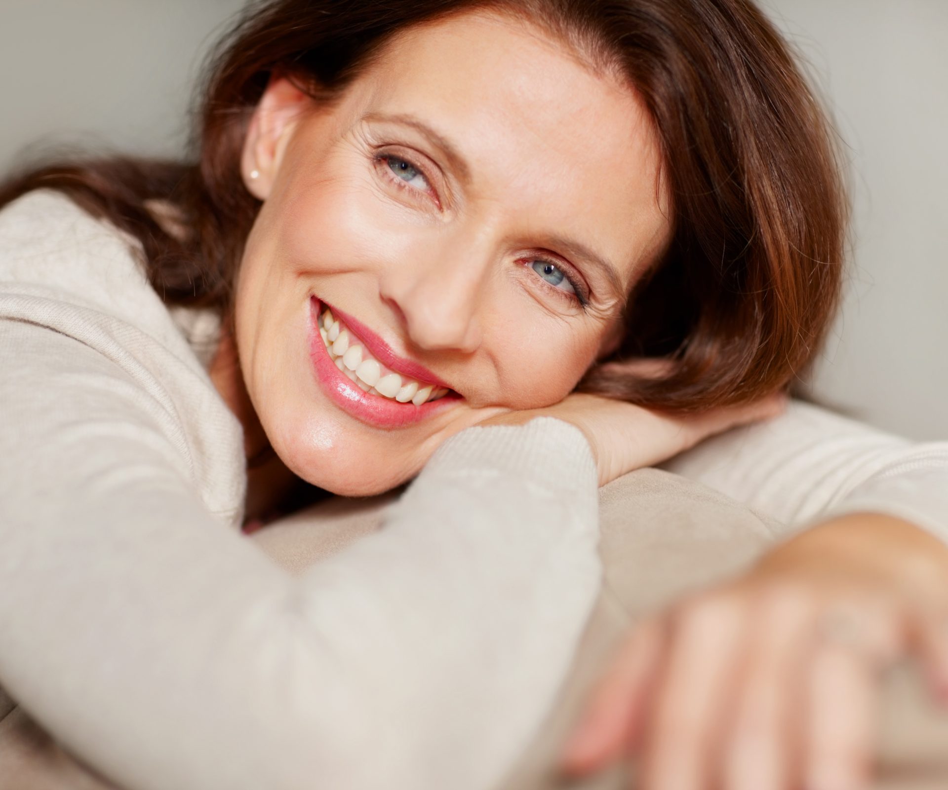 Closeup of a smiling mature lady relaxing on couch Senior patient having an eye exam at ophthalmologist's office